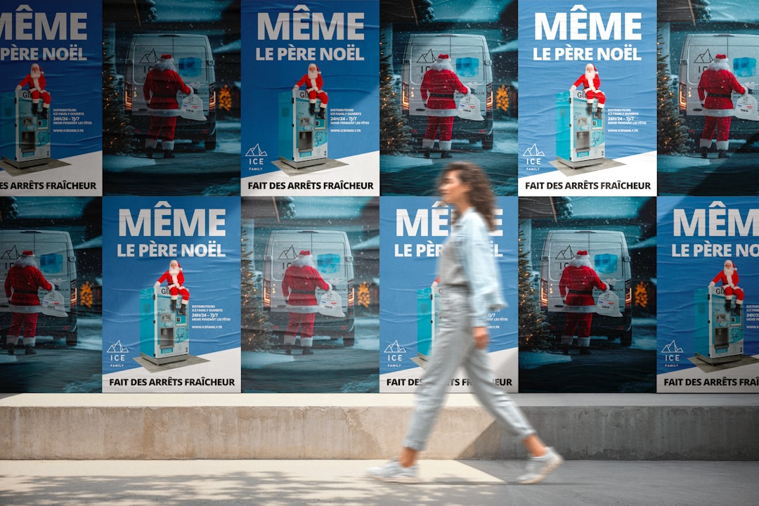 woman-walks-past-posters-of-santa-claus-vtx5syexgqc